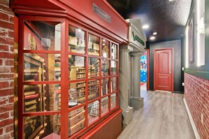 A red brick building with a glass display case filled with books and vintage items. - 5BR Disney-area Home Pool, Theater, Themed (Kissimmee)