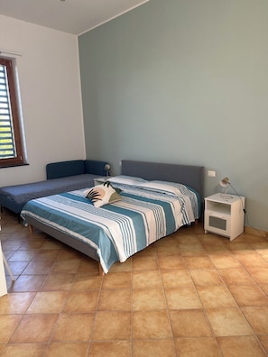A bedroom with a bed, a nightstand, and a window. - Residenza Don Alfonso (Somma Vesuviana)
