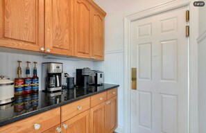 A well-equipped coffee bar with natural wood cabinetry and dark countertops. - Hamptons Retreat | Private Pool & 3BR Escape (East Quogue)