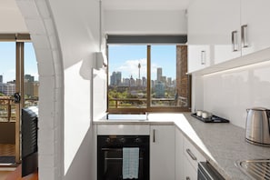 Una cucina moderna con vista sulla città, dotata di forno a incasso e finestra con vista sullo skyline.