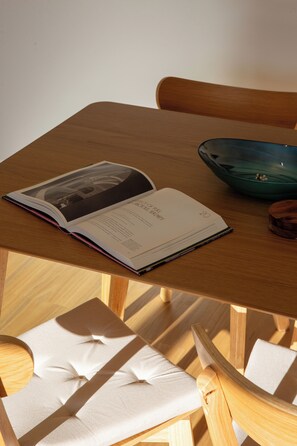A book open on a wooden table, a green bowl, and a chair. - Sydney Panorama Iconic City Views and Rooftop Pool (Potts Point)