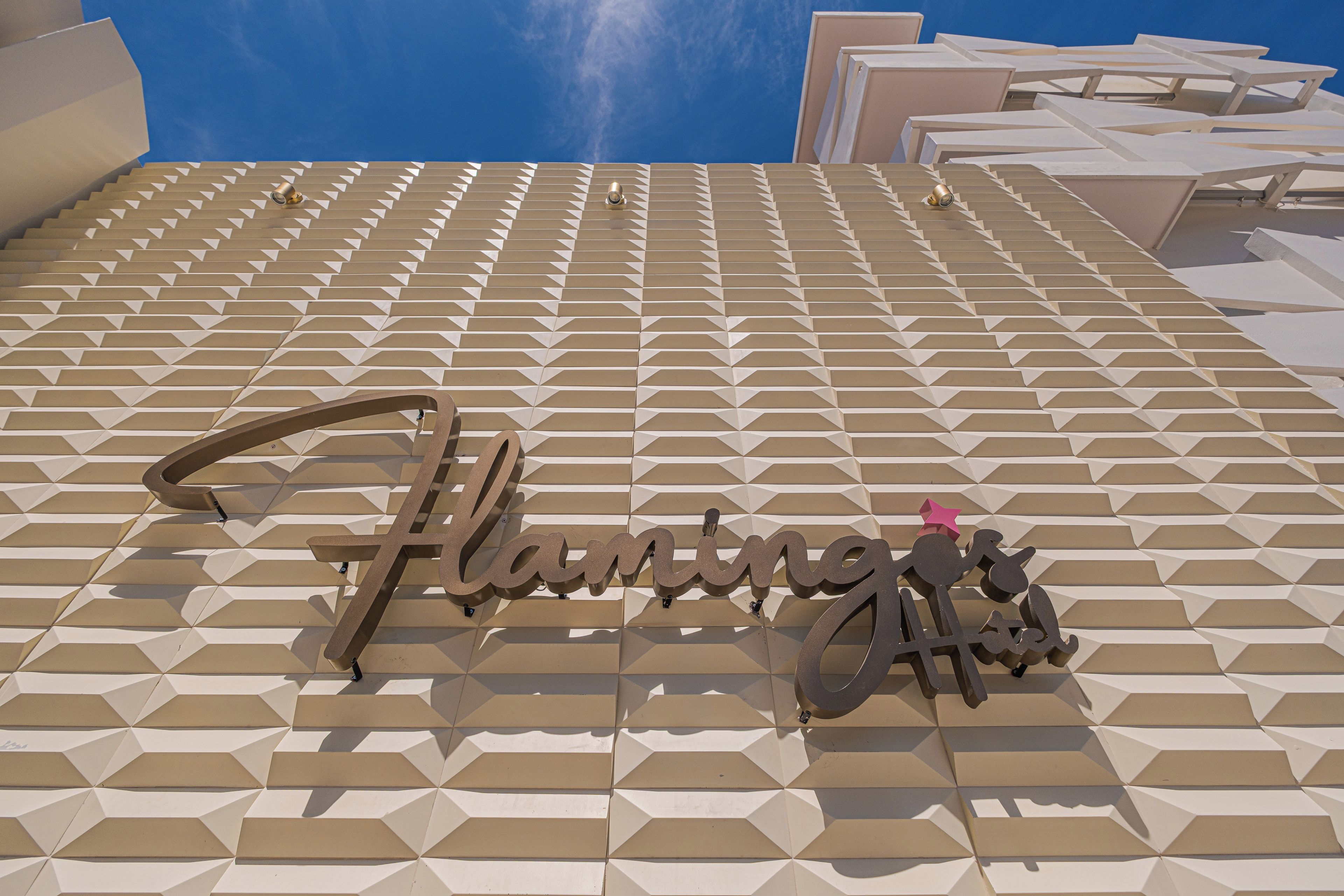 A geometric patterned facade with the name 'Flamingo's' prominently displayed.