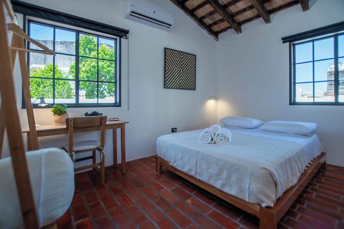 Bedroom with garden view windows