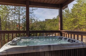 A hot tub under a wooden deck with a forest view. - Liam's Lookout | Smoky Mtn Cabin, Hot Tub & BBQ (Sevierville)