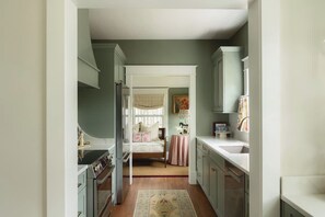 Kitchen: Cook and gather in this bright, well-equipped kitchen featuring generous counter space, essential appliances, and everything needed for easy meals during your stay.
