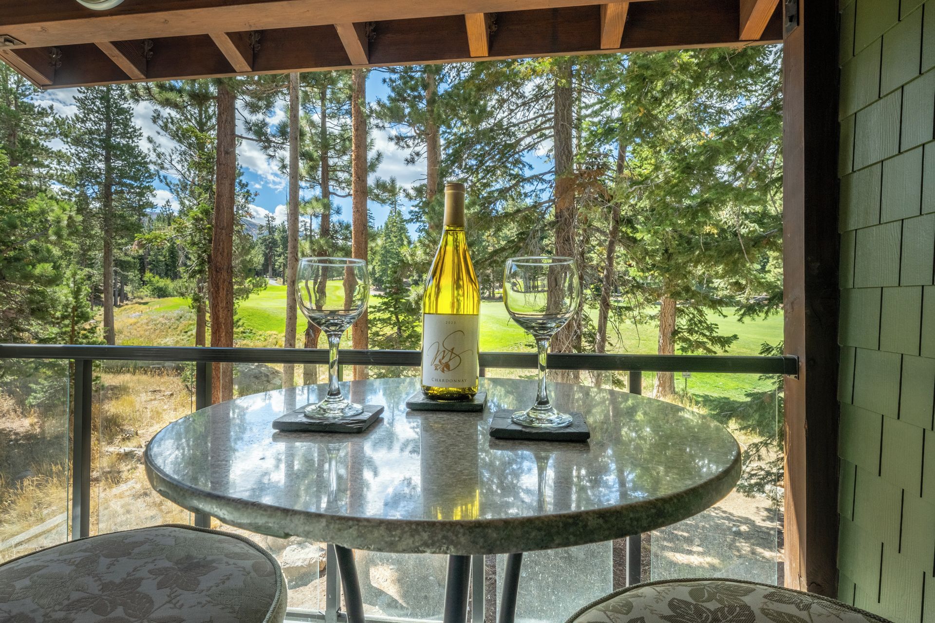 Sip your morning coffee or evening wine at your private balcony table, where towering pines frame a peaceful forest and fairway view. The perfect spot to unwind and soak in the natural beauty surrounding you.