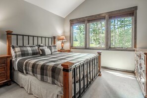 Wake up to sunlight streaming through large windows overlooking a peaceful wooded landscape. Your cozy bedroom invites restful mornings and quiet evenings in a serene natural setting. - Golf Course Views | Private Hot Tub (Mammoth Lakes)
