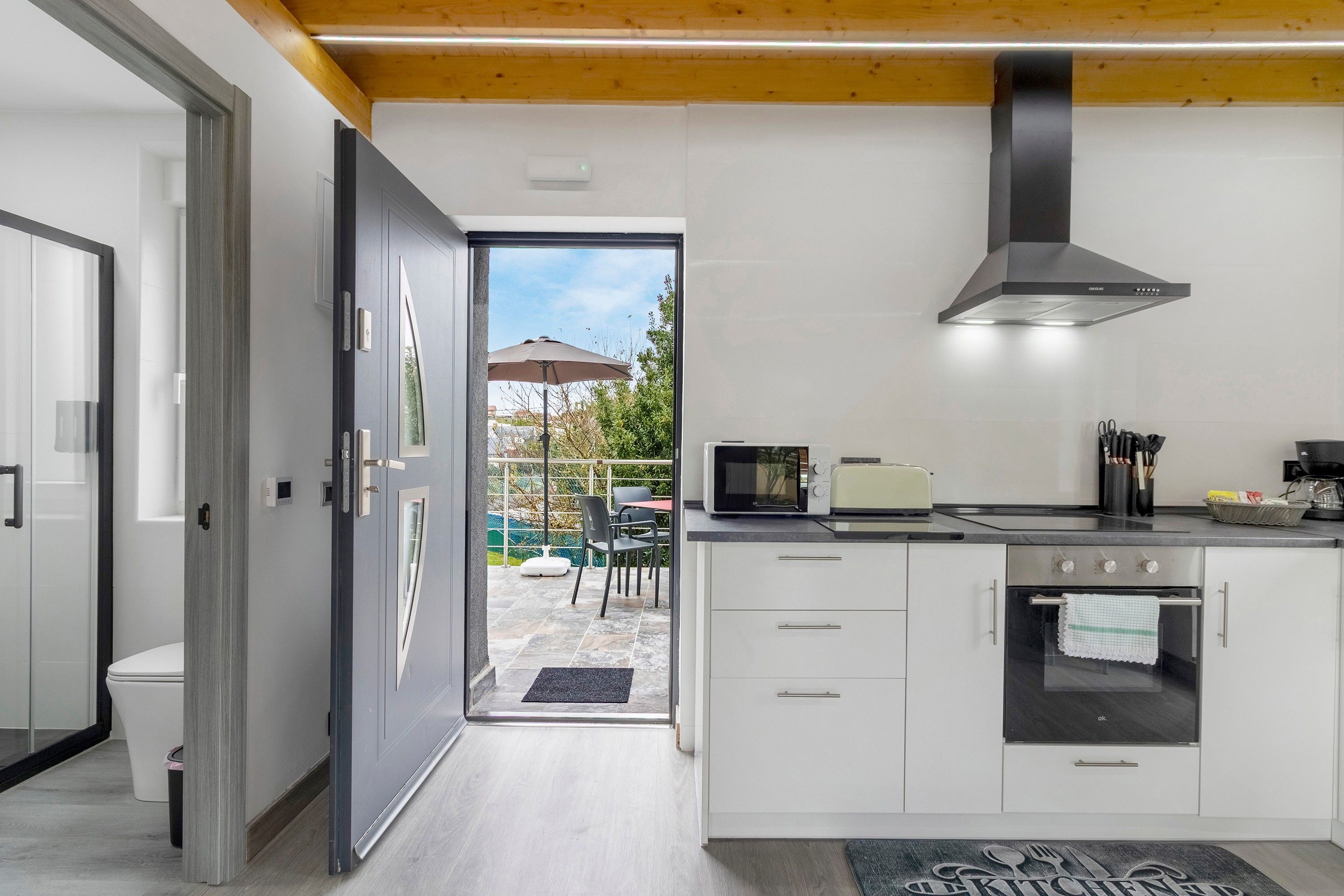 A modern kitchen with a built-in oven, microwave, and toaster.