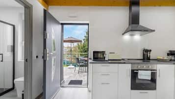 A modern kitchen with a built-in oven, microwave, and toaster.