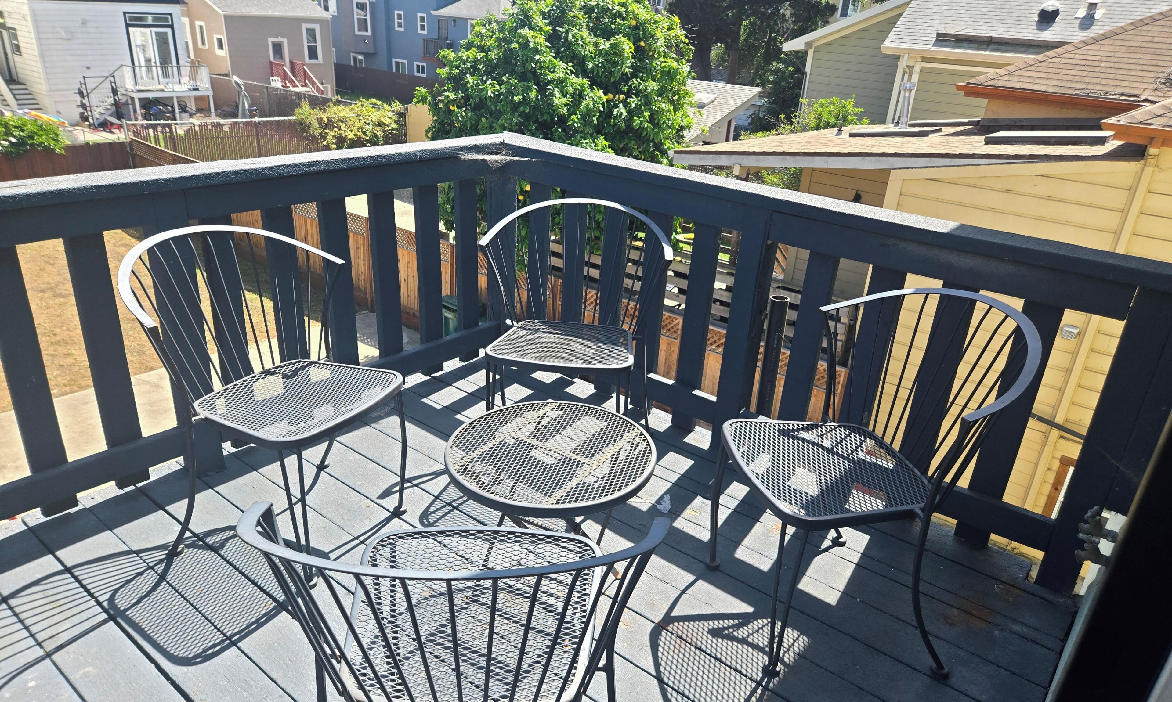 A deck with a table and four chairs.