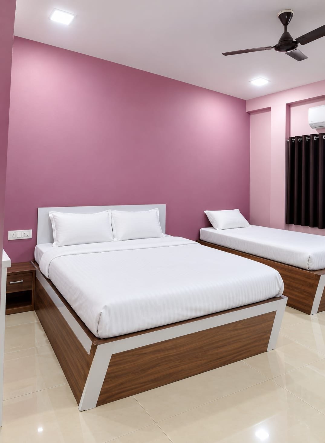 A bedroom with two beds, a ceiling fan, and a window with curtains.