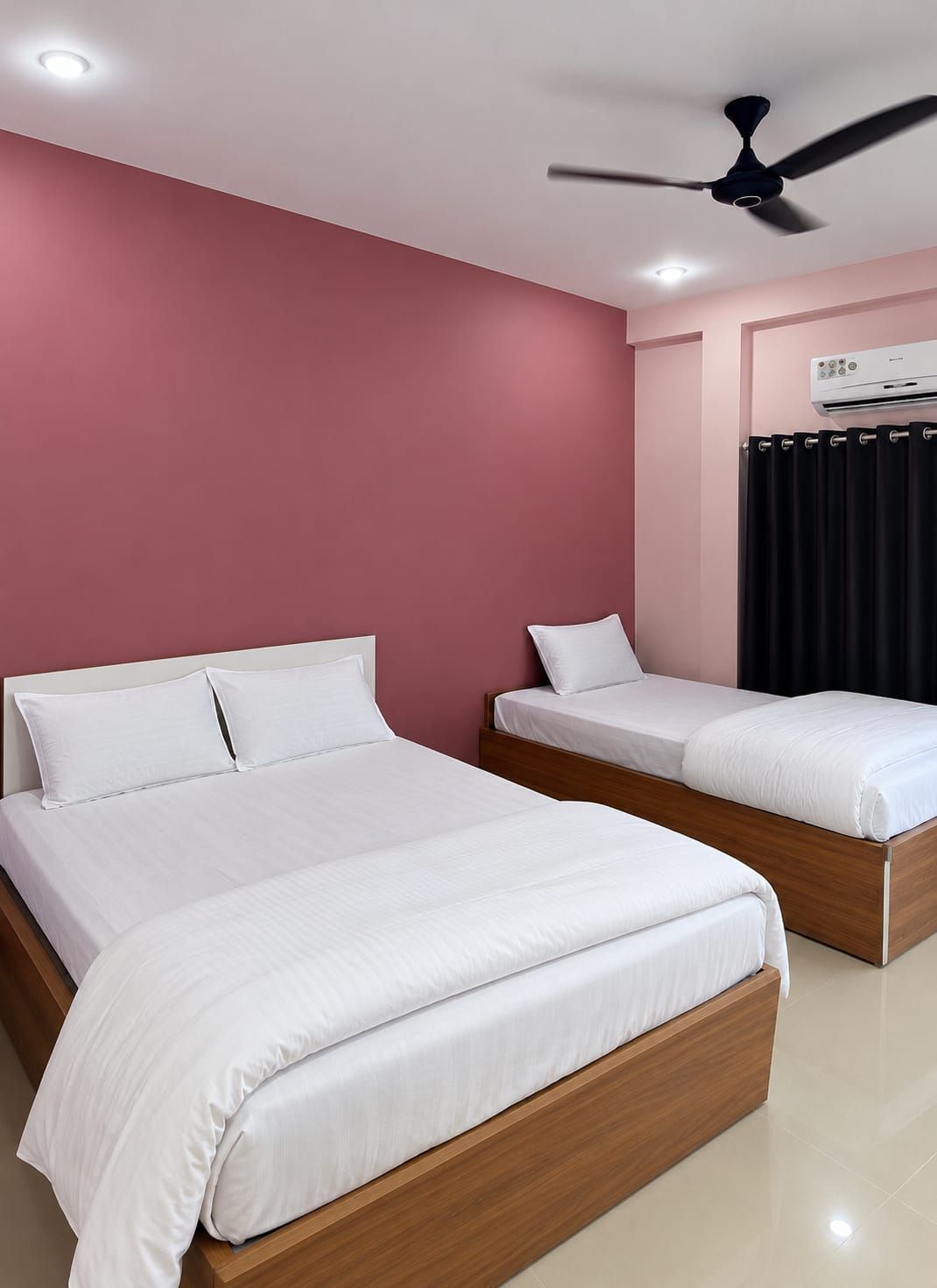 A bedroom with two beds, a ceiling fan, and an air conditioning unit.