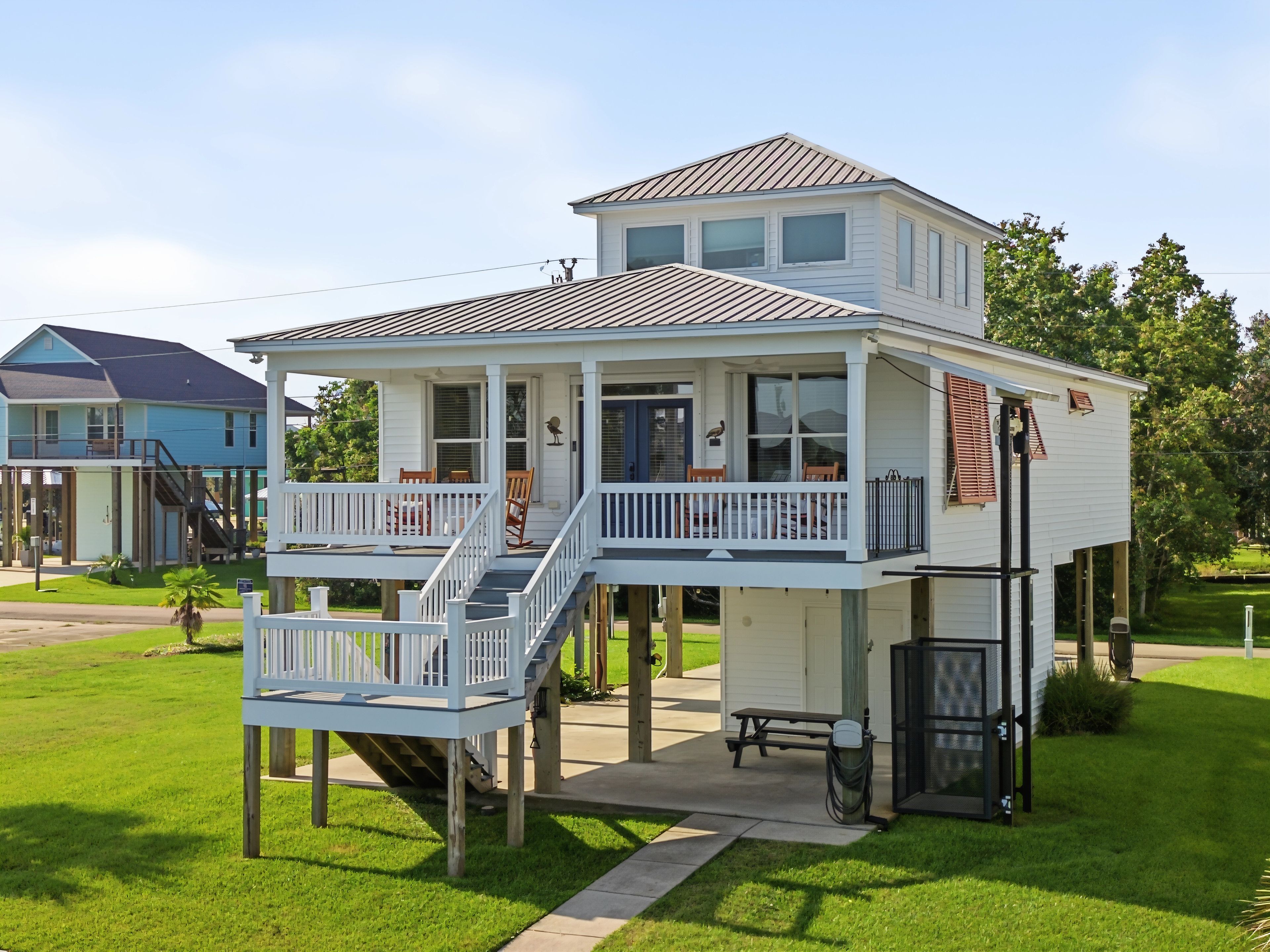 A two-story house with a balcony, a covered porch, and a small attached garage.