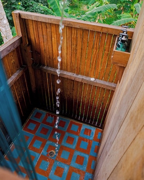 A wooden structure with a tiled floor and a water spout. - Luzul Ecohotel (Arusi)
