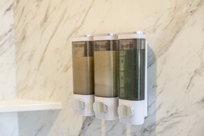 A set of three dispensers on a marble wall, labeled for conditioner, body wash, and shampoo. - Cozy Black Hills Rustic Cabin Queen & Twin Trundle Heat AC WiFi Bathhouse Nearby (Piedmont)