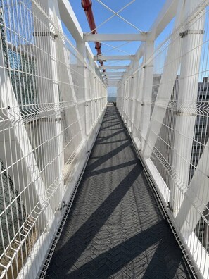 A pedestrian bridge with metal railings and a patterned walkway. - Sienna Grove | Terrace, Caribbean Views & Pool (Cartagena)