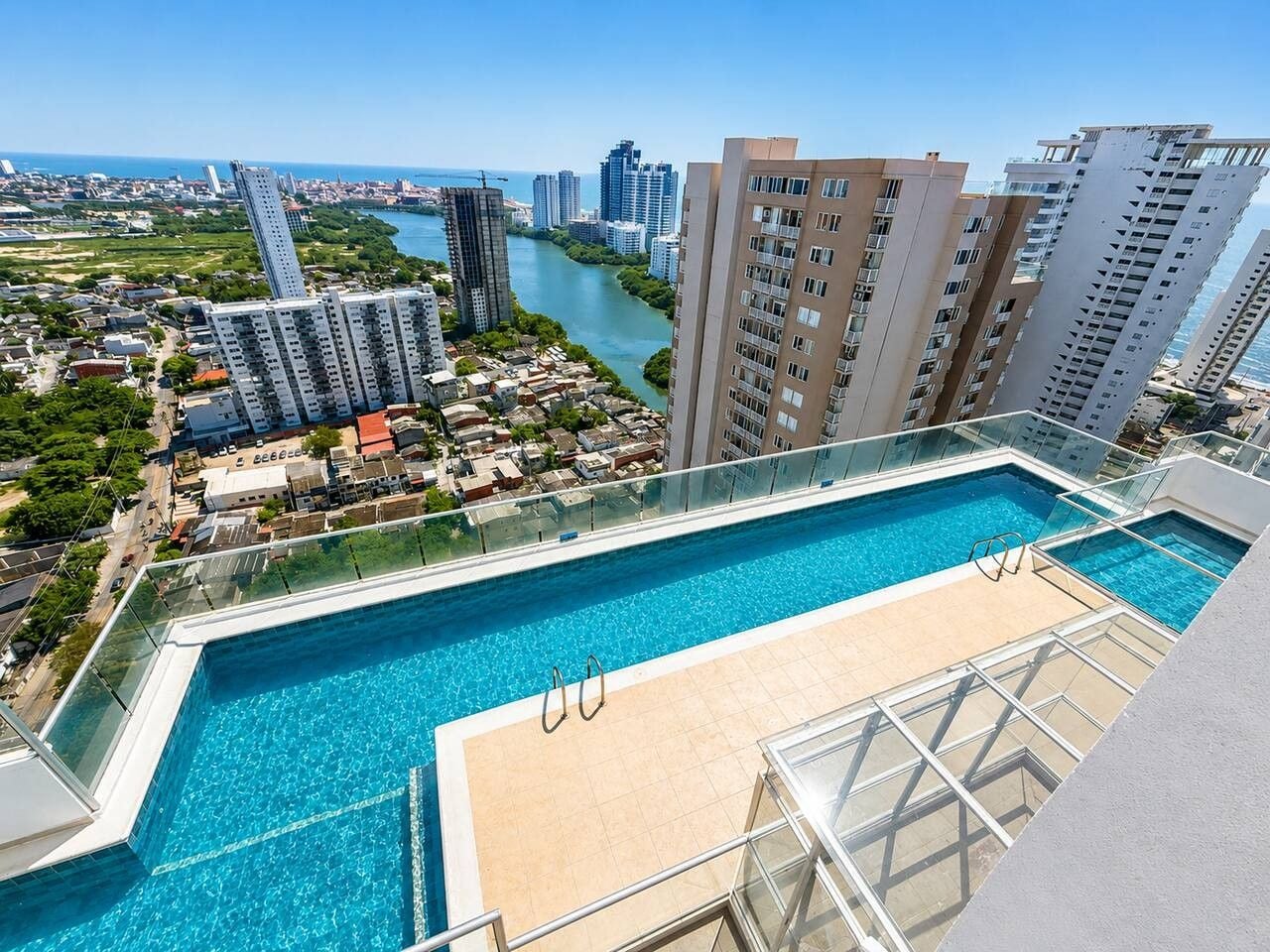 A rooftop pool with a clear view of a river and cityscape.
