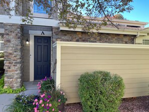 A house with a stone facade, a dark blue door, and a beige garage door. - SunDance Film Festival Travelers: Cosy 2-bedroom condo  in adorable Broomfield (Broomfield)
