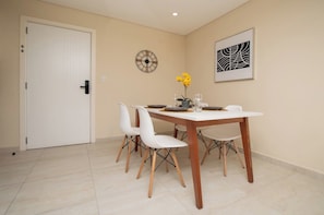 Dining table set for four - Remote Work Retreat, Balcony, BBQ, Pool & Gym (Asunción)