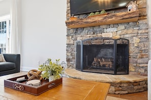 The beautiful stone fireplace adds so much character to the main living space and gives it that cozy lake-house feel. - Lakefront retreat with dock, kayaks & firepit (Albemarle)