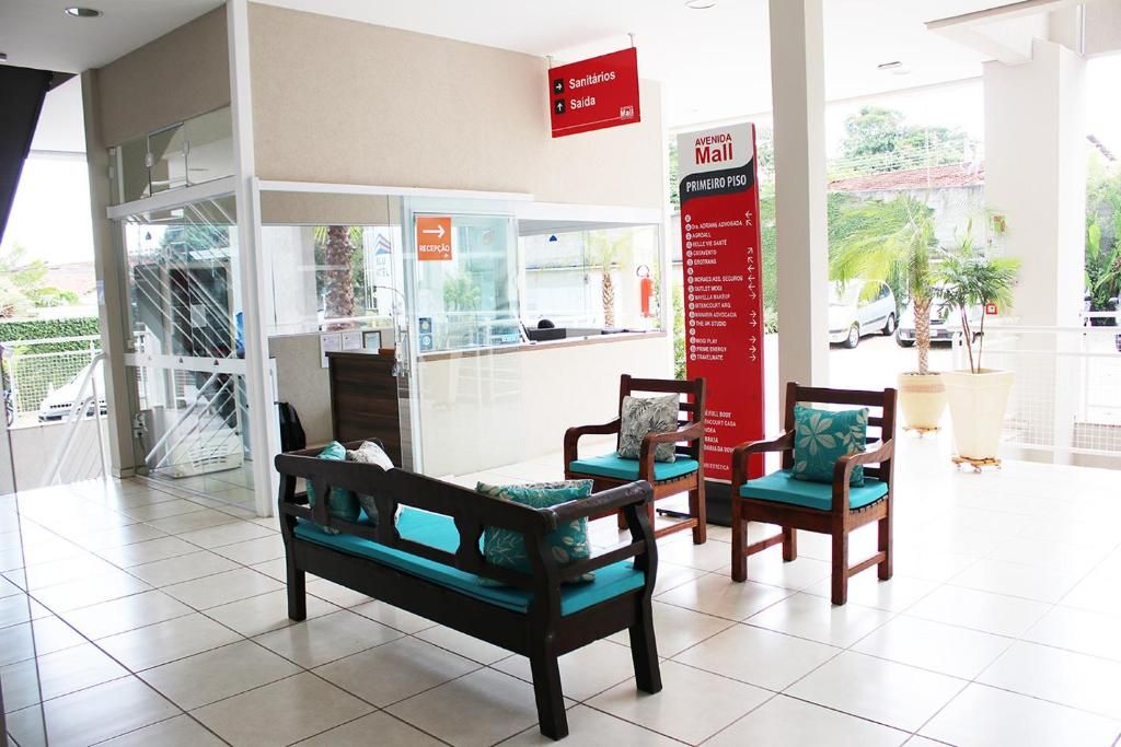 A reception area with a reception desk, a staircase, and a view of the outside.