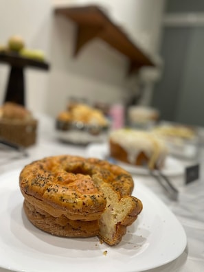 A bagel with a bite taken out of it on a white plate. - Blu Apart Hotel (Mogi-Guacu)