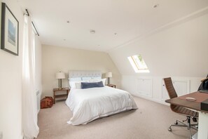 A bedroom with a bed, bedside tables, a desk with a chair, a window, and a door. - 5 Bed in Devizes (oc-s34742) (Devizes)