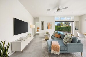 Settle in for movie night, catch up at the desk, or keep the patio in view from the living space. - Modern Oasis in Central Palm Springs (Palm Springs)