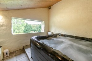 A hot tub in a room with a window, a white wall, and a tiled floor. - 1 Bed in Duloe (oc-h27527) (Duloe)