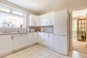 A modern kitchen with white cabinetry, a dishwasher, and a refrigerator. - 4 Bed in Chesterfield (oc-w45546) (Chesterfield)