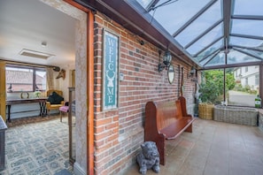 A brick exterior with a 'WELCOME' sign, a bench, and a dog statue. - 8 Bed in Gillingham (oc-w45983) (Gillingham)