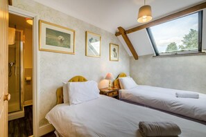 A room with two beds, a window, and framed pictures on the wall. - 8 Bed in Gillingham (oc-w45983) (Gillingham)