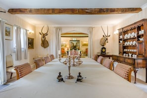 A dining room with a long table, chairs, and antler decorations. - 8 Bed in Gillingham (oc-w45983) (Gillingham)