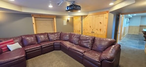 Cozy media room with oversized sectional and ceiling-mounted projector - Timberland - Hot Tub, Theater & Wooded Retreat (Garden City)
