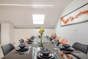A conference room with a long table set for a meeting, equipped with chairs, plates, cutlery, and glasses. - 5 Bed in Cerrigydrudion (oc-c45945) (Cerrigydrudion)