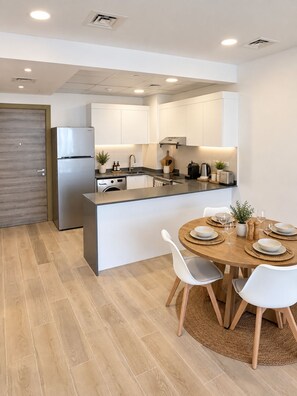 Private kitchen - Top-Floor JVC Stay  Sunset & Skyline Views (Dubai)