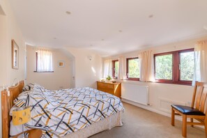 A bedroom with a bed, a dresser, a chair, and a window with curtains. - 1 Bed in Wool (oc-c45498) (Wool)