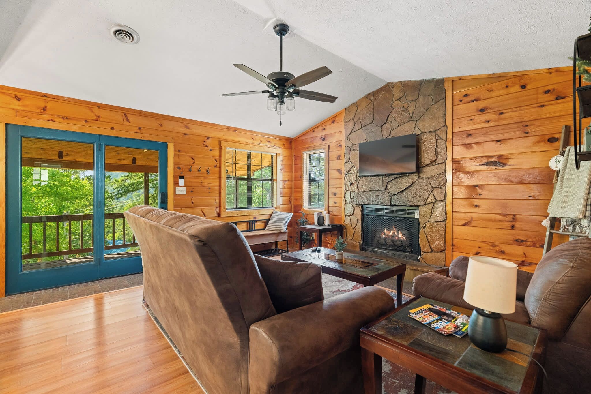 Cozy living room with stone gas fireplace. Tons of natural light. 