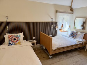 A hotel room with two beds, a bedside table, a mirror, and a window with curtains. - 2 Bed in Sparham (oc-c46027) (Lyng)