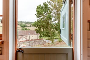 A door with a view of a rural landscape, including houses and trees. - 1 Bed in Batheaston (oc-f45918) (Batheaston)