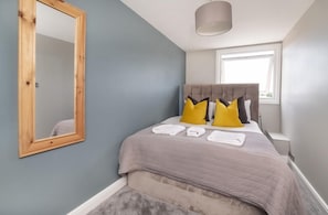 A bedroom with a bed, a mirror, a window, and a ceiling light fixture. - 7 Bed in Earswick (oc-s46053) (Earswick)