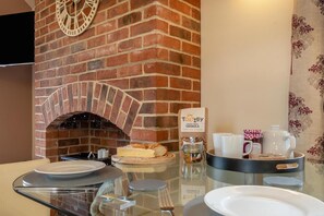 A breakfast setup with a brick oven, a jar of granola, and a coffee pot. - 2 Bed in Yoxall (oc-s46075) (Hadley End)