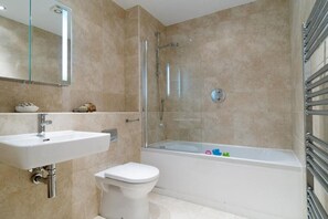 A bathroom with a glass-enclosed shower, a white sink, and a toilet. - 3 Bed in Porth (oc-b584338) (Newquay)