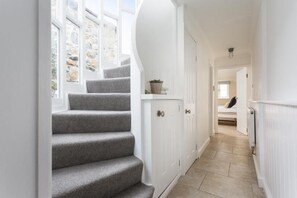 A staircase leading to a bedroom with a view of a stone wall and a window. - 2 Bed in Mousehole (oc-b584390) (Mousehole)