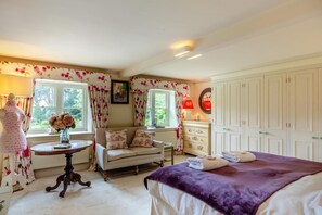 A bedroom with a bed, a dresser, a vanity, a window with curtains, and a mannequin. - 5 Bed in Marnhull (oc-t46058) (Marnhull)