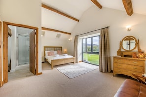 A bedroom with a bed, a dresser, a mirror, and a large window with curtains. - 4 Bed in Rhayader (oc-c46317) (Rhayader)