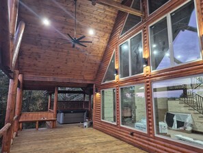 A wooden cabin with a large deck, a ceiling fan, and multiple windows. - Brand New !! - Coming between Nov 23rd - Dec 1st, 2026. Check back soon!! (Smithville)