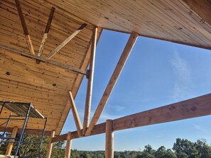 Eine Holzkonstruktion mit blauem Himmel, der durch das Dach hindurchscheint.