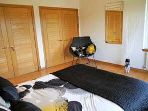 A bedroom with a bed, a chair, a mirror, and a vase. - 4 Bed in Portpatrick (oc-d587345) (Portpatrick)