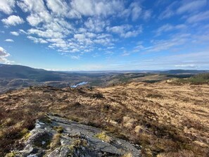 A panoramic view of a hilly landscape with a clear sky and distant mountains. - 2 Bed in Glentrool, Newton Stewart (oc-d616822) (Glentrool)